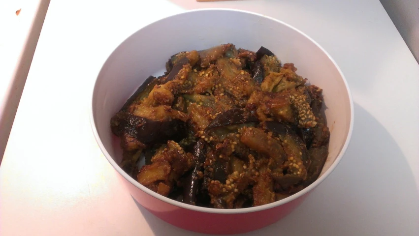 a bowl filled with food sitting on top of a table