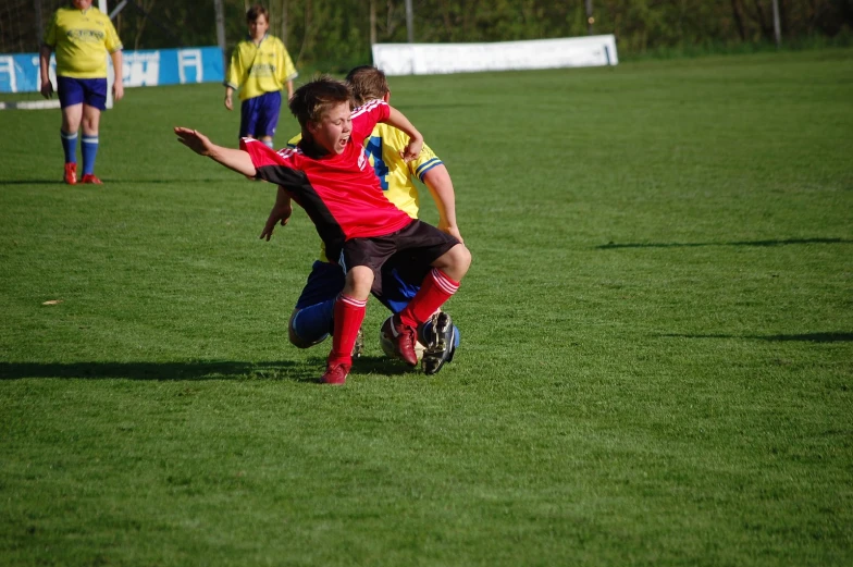 the soccer players are chasing after the ball