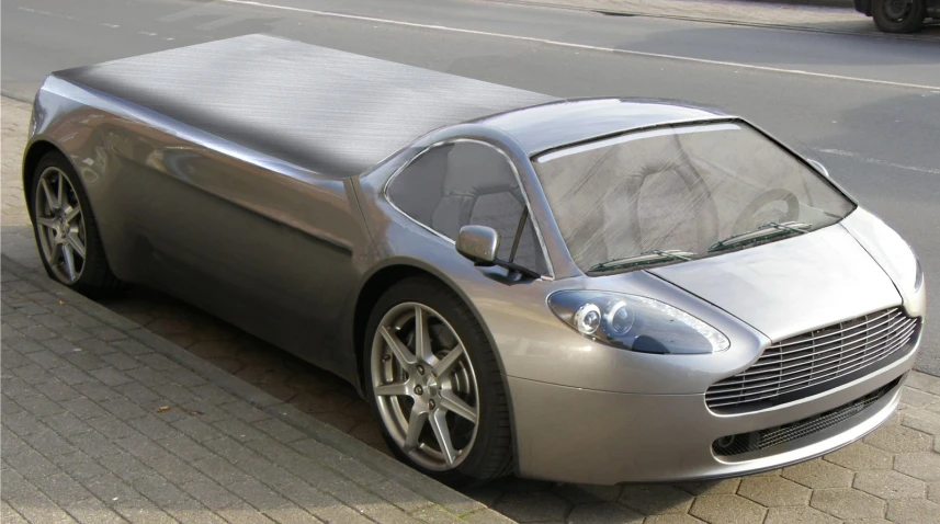 the silver sports car is parked on the sidewalk