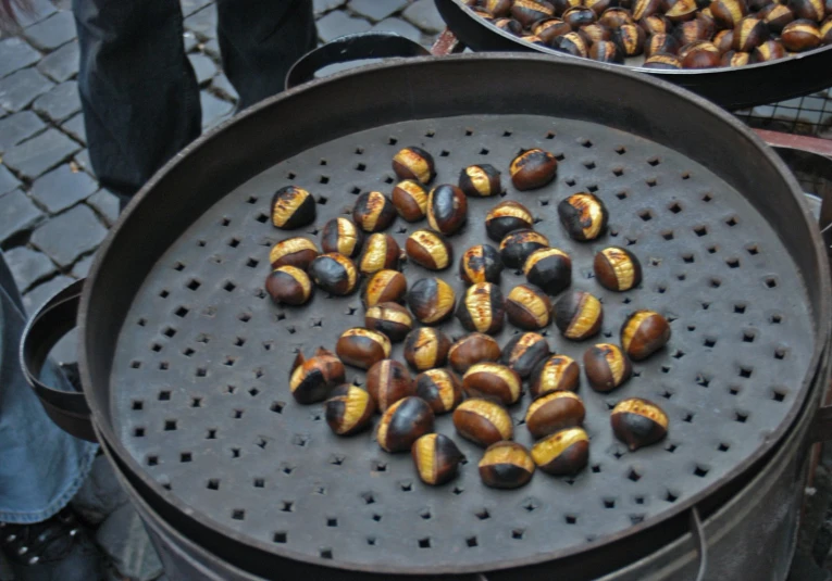 there are many chestnuts on a tray and on a grill