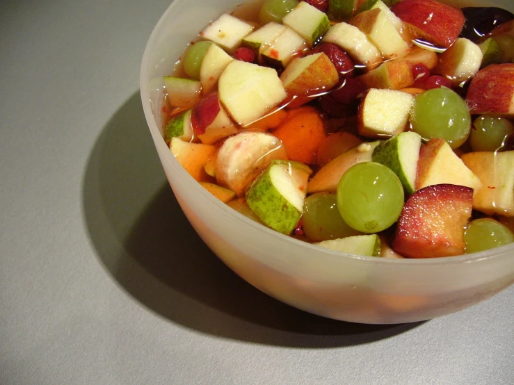 there is soing green in this bowl and red, white, and green apples