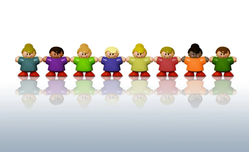 an array of small plastic figures sitting on a shiny surface