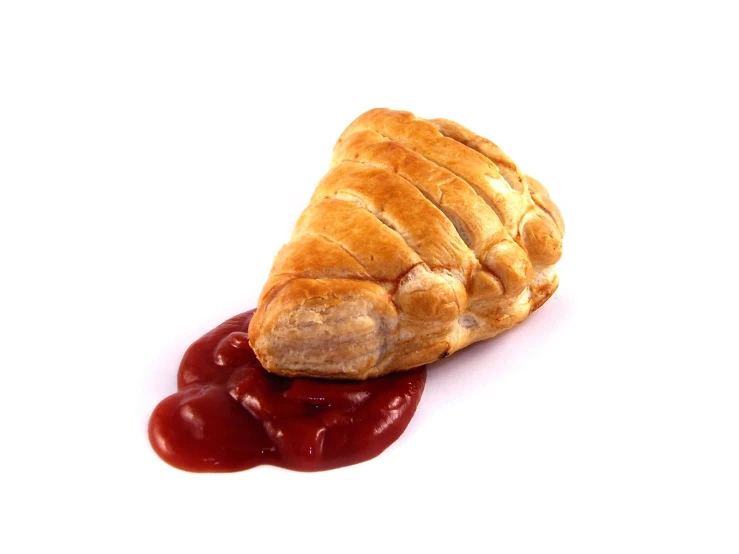 a pastry sitting on top of red sauce