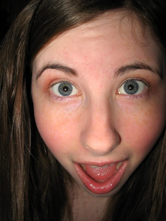 girl making a funny face with red lipstick