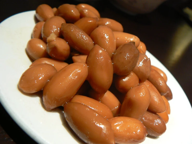 a bunch of peanuts sit on a plate