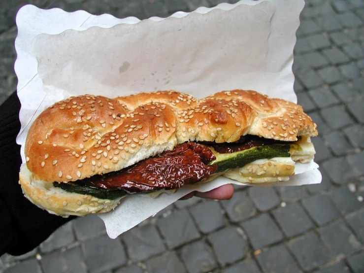 the sandwich is stuffed with meat and vegetables