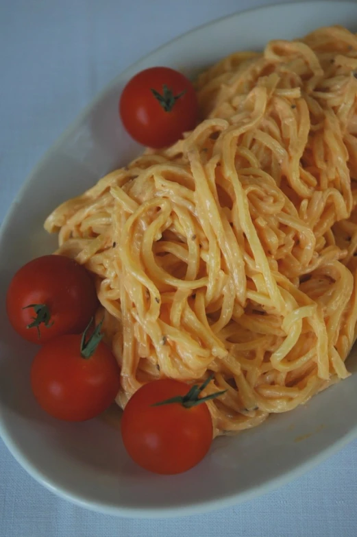 a plate of pasta and cherry tomatoes