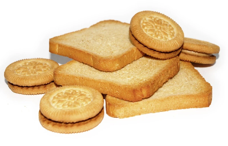 a few slices of white bread with a pile of cookies on the side