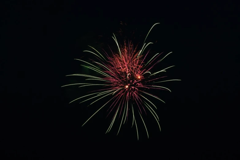 a beautiful display of fireworks on a dark night