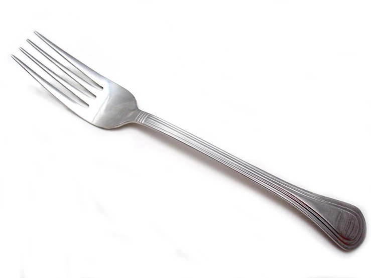 an old fork with metal handles is against a white background