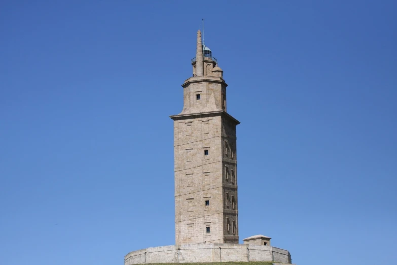 a large stone tower with a small clock at the top