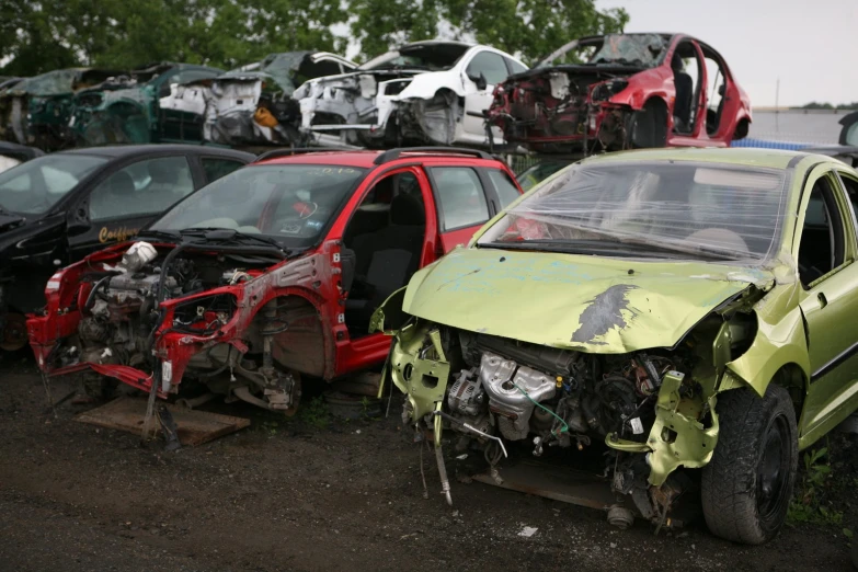 a lot of old cars are broken down and parked