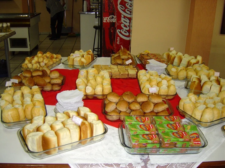 a table is covered in plates of buns and cans