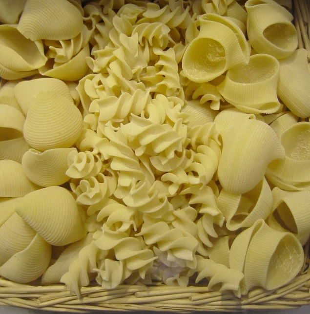 close up po of yellow pasta pieces in a basket