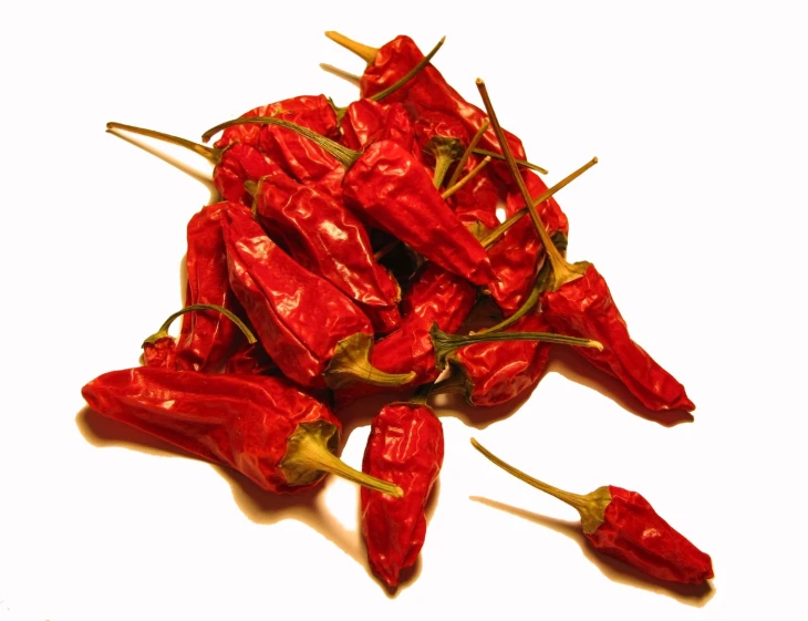 red  peppers are shown against a white background