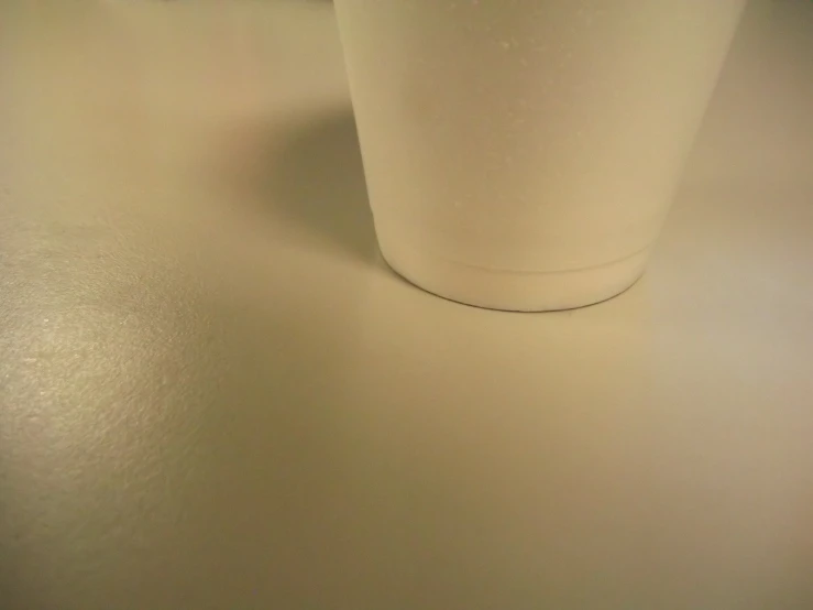 three empty plastic cups on a counter in a kitchen