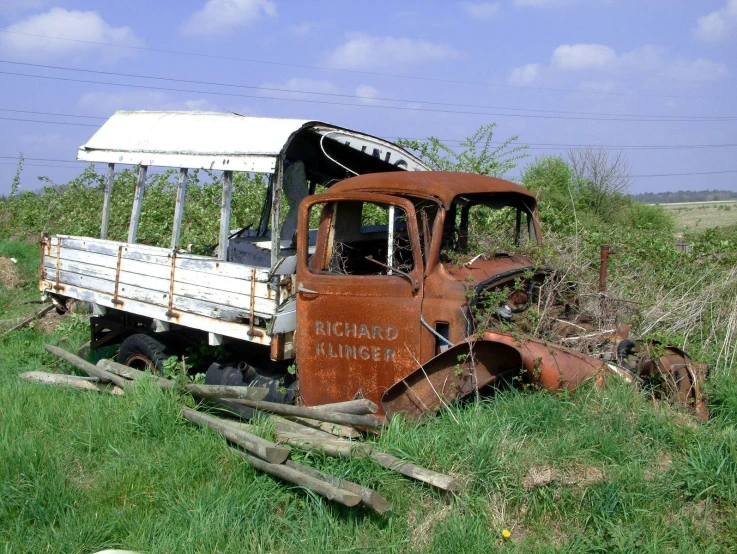 an old rusty truck in the middle of nowhere