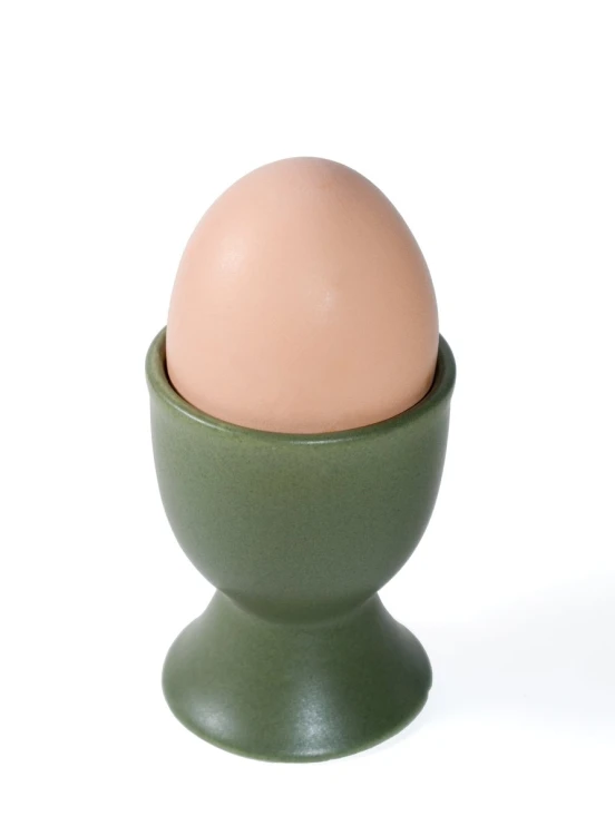 an egg is in a green egg cup