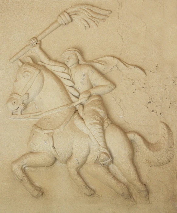 two men are riding horses in the sand