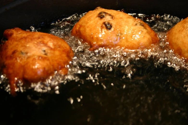 four small food items frying in a set