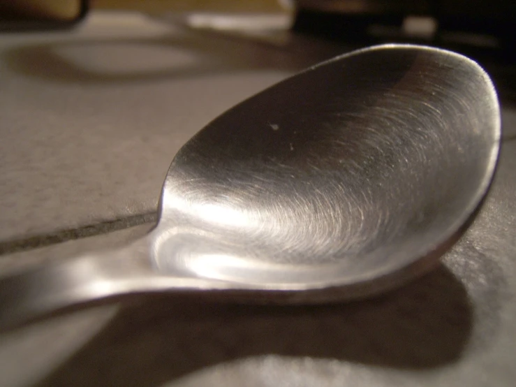 the shiny spoon has a little piece of writing on it
