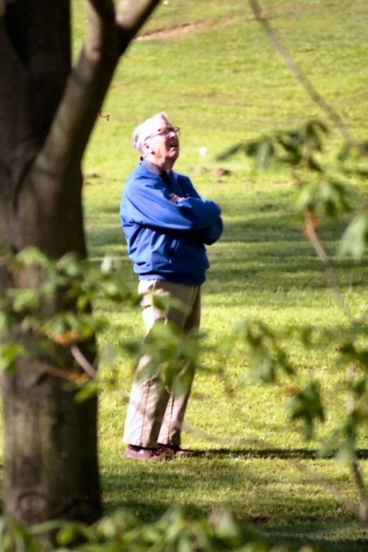 an old man is looking in a field