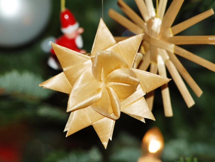 a toy star hanging on a christmas tree