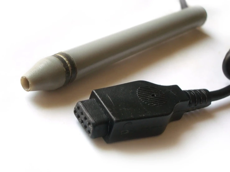 a close up of a pen and a cable