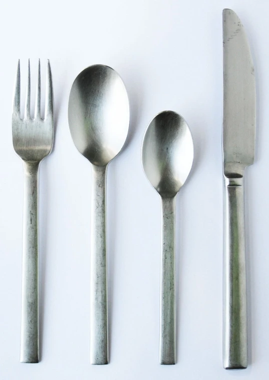 a close up of various utensils on a white surface