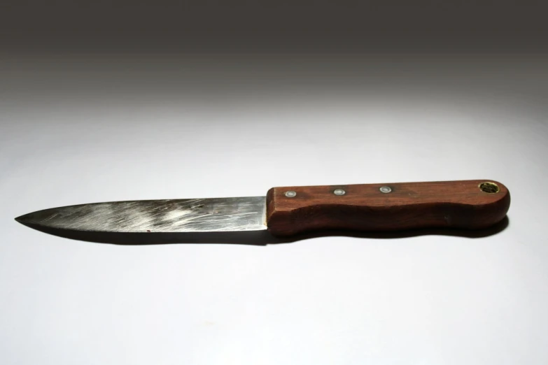 a close up view of a knife on a white surface