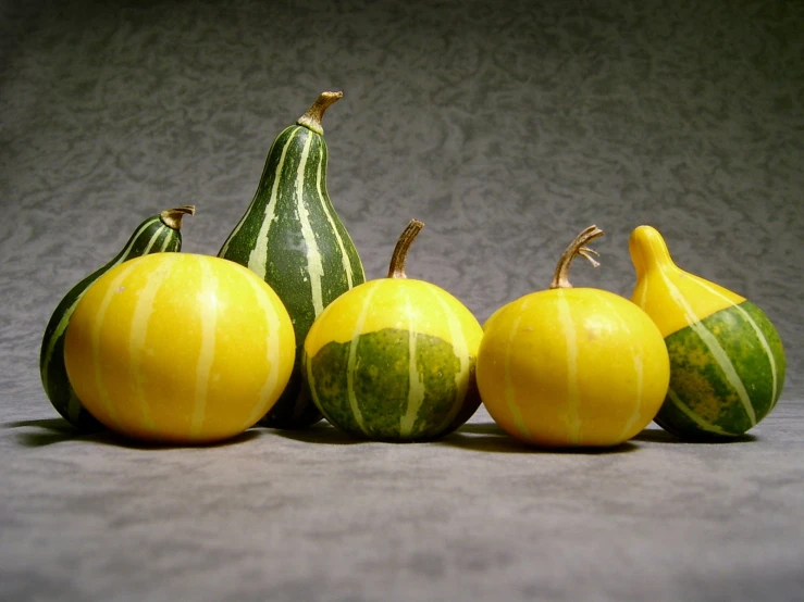 a couple of watermelon and a yellow squash