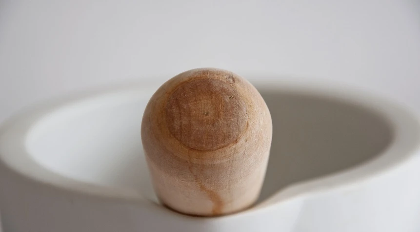 a small wooden object sitting on top of a white counter