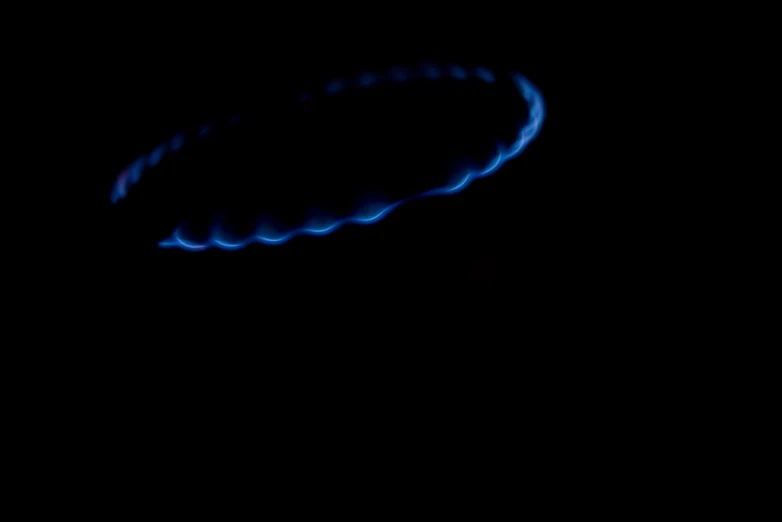 a lit up blue ring over a dark sky