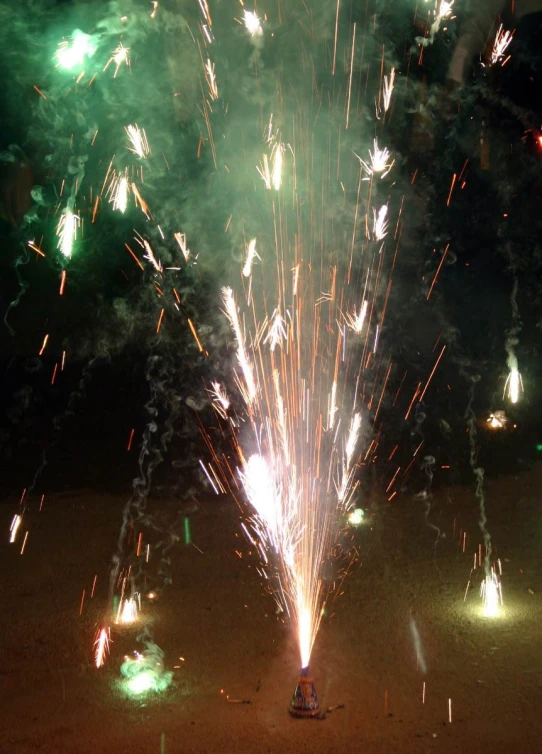 a fireworks show being carried on an open field