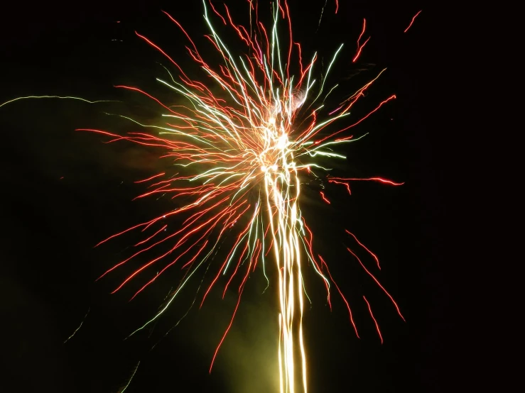 an abstract s of colorful fireworks against black background