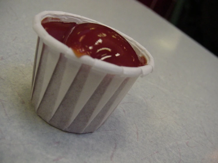 the small cup with sauce in it is ready to be eaten