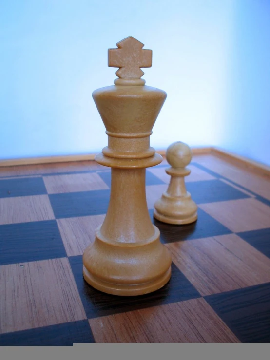 a pawn sitting next to a chess board