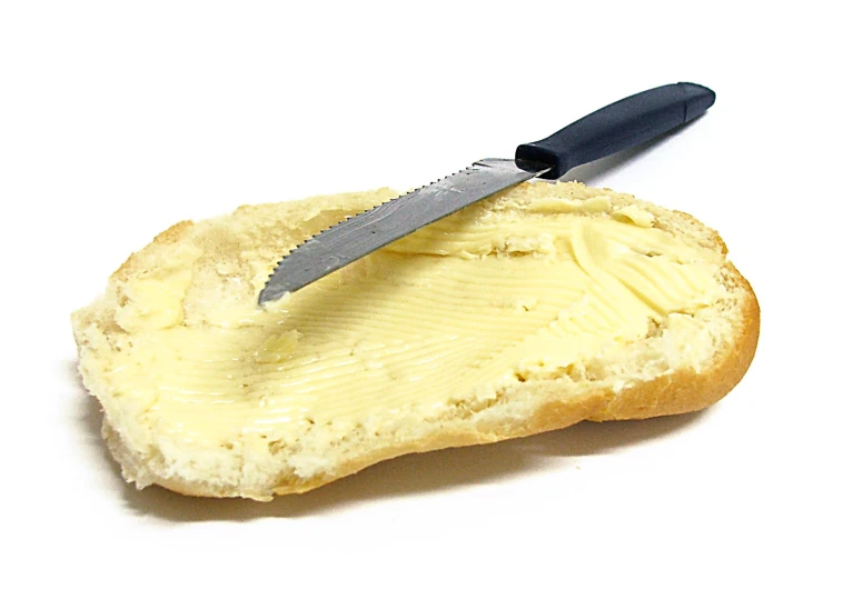 a knife is on top of a piece of bread