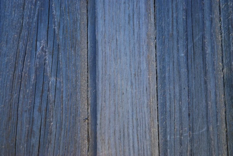 the blue wooden wall is covered with thin wood