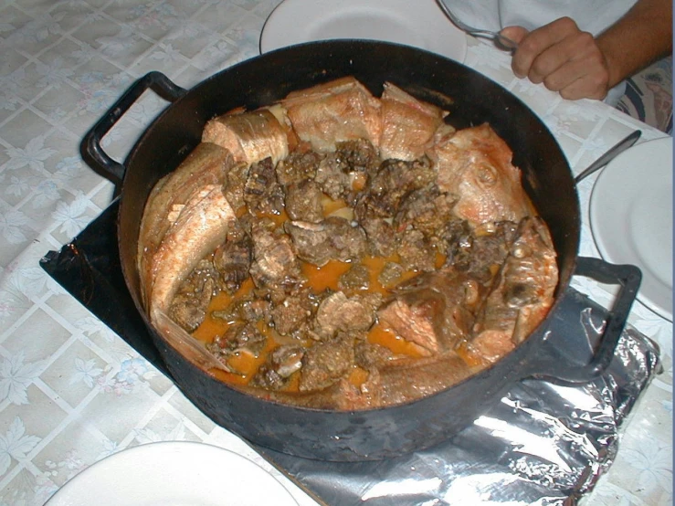 a stew is sitting on top of an old cast iron set