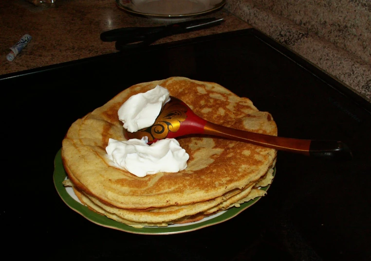 pancakes sitting on top of a green and white plate