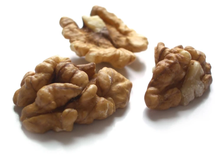 walnuts are falling apart, on a white surface