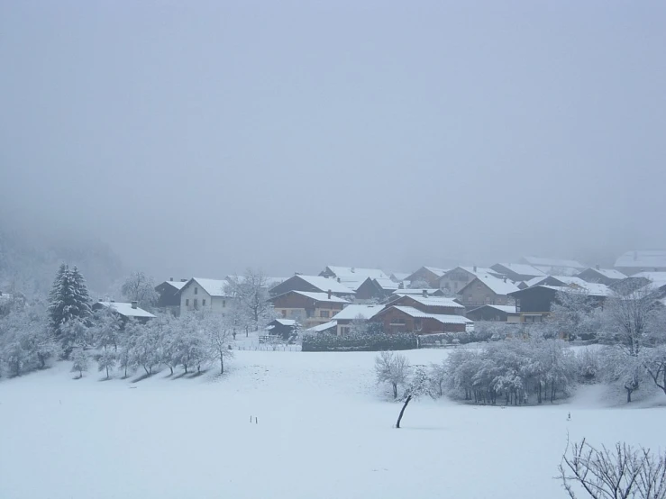 a city is surrounded by snow covered buildings