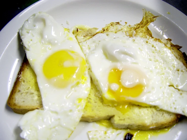 two fried eggs in the middle of toast