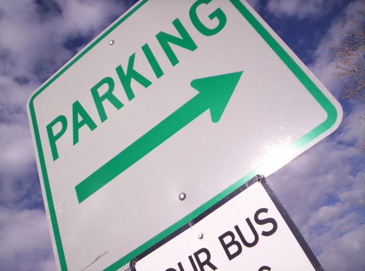 a parking sign that reads tour bus zone on it