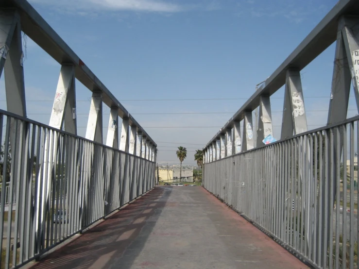 a walkway leading to a building with a stop sign