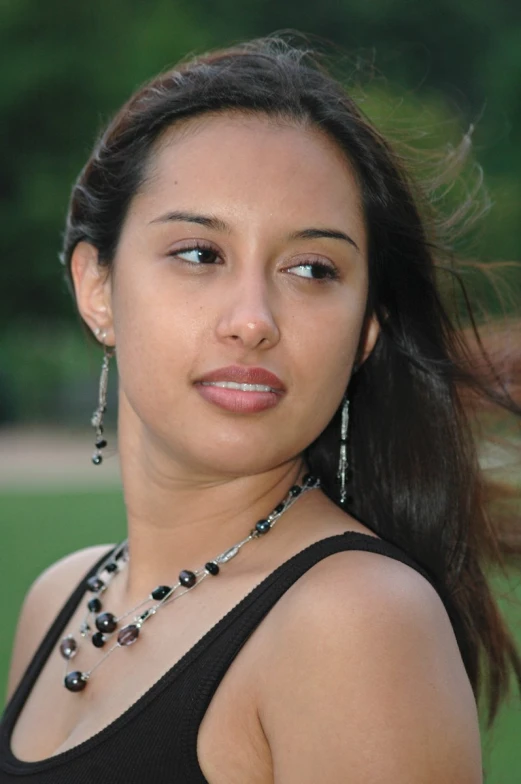 a girl poses for a po in a black tank top