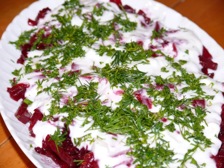 a white plate topped with sour cream and cranberry sauce
