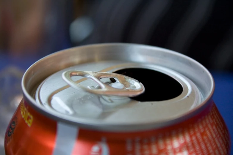 a closeup of an open can with a black substance on the end