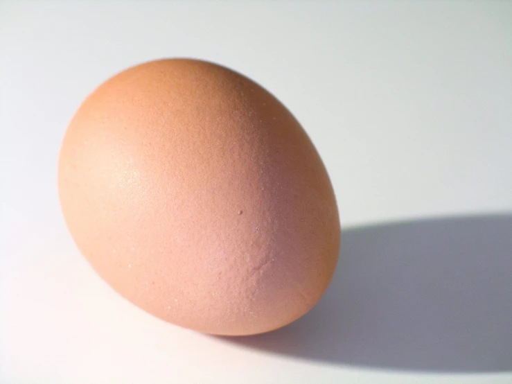 an egg sitting on a white table top